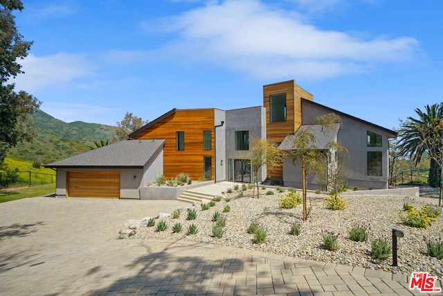 modern home with a mountain view and a garage