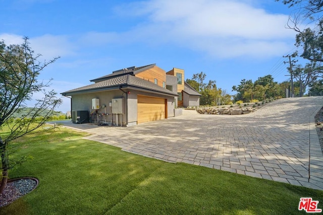 back of property with a yard and central air condition unit