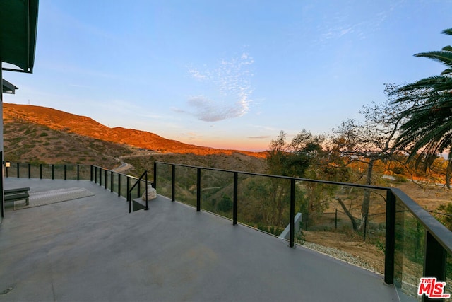 balcony at dusk with a mountain view