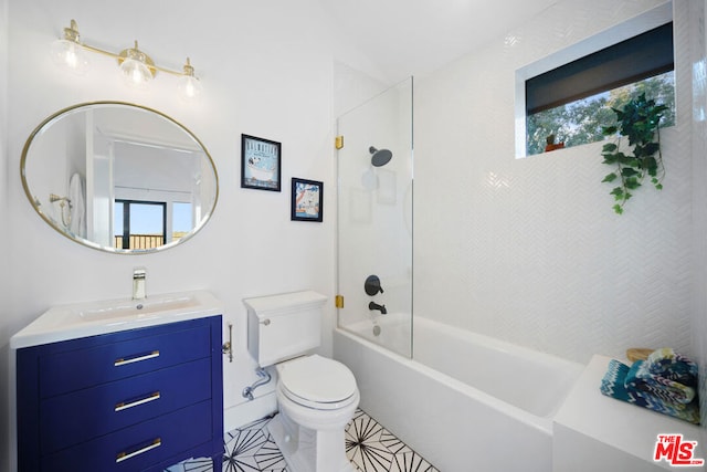 full bathroom featuring vanity, tiled shower / bath, and toilet