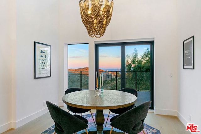 dining space featuring a chandelier and light hardwood / wood-style floors