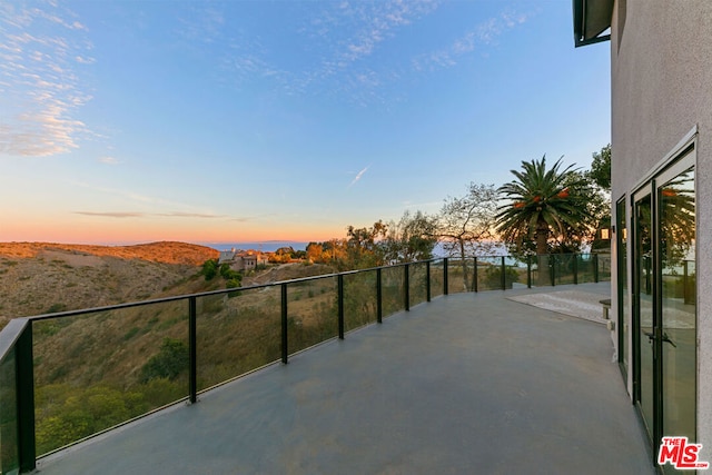 balcony at dusk with a mountain view