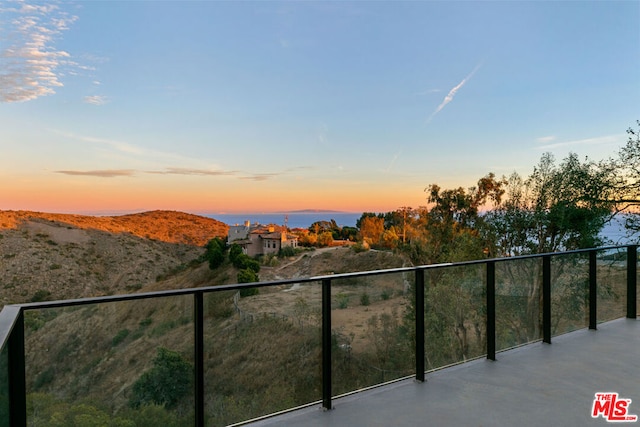 balcony at dusk with a mountain view