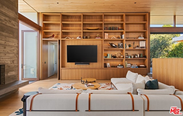 living room featuring hardwood / wood-style floors and wood walls