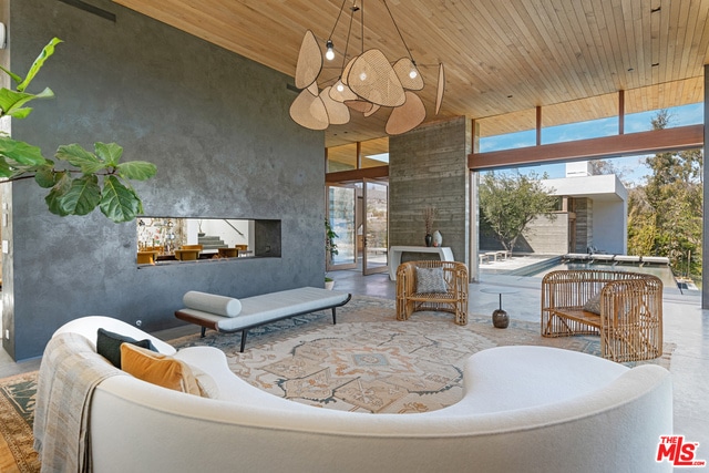 living room featuring wooden ceiling and a multi sided fireplace