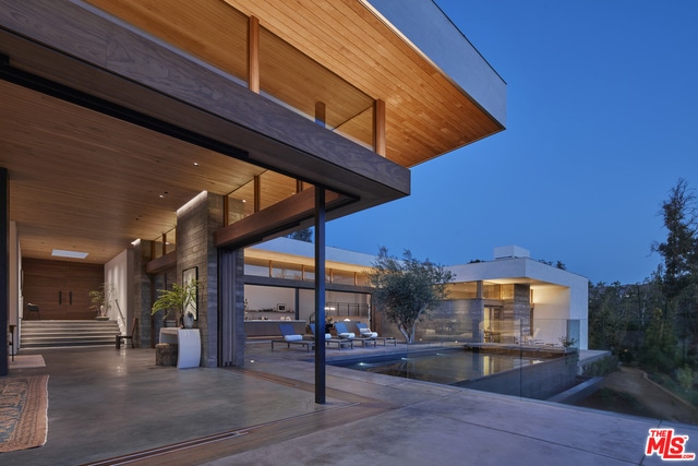 pool at dusk featuring a patio area