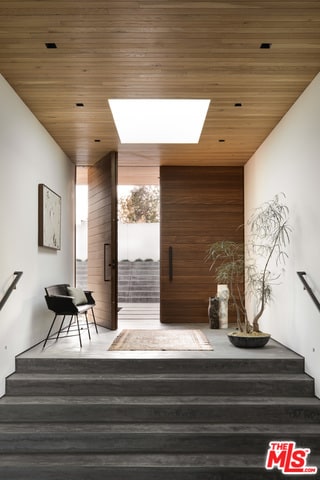 stairway with a skylight and wood ceiling