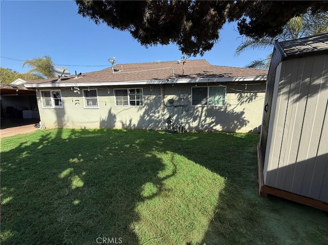 rear view of property featuring a lawn