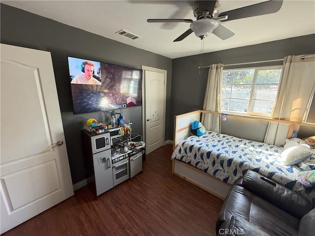 bedroom with ceiling fan and dark wood-type flooring