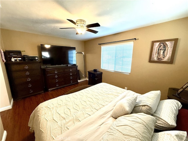 bedroom featuring ceiling fan and dark hardwood / wood-style floors