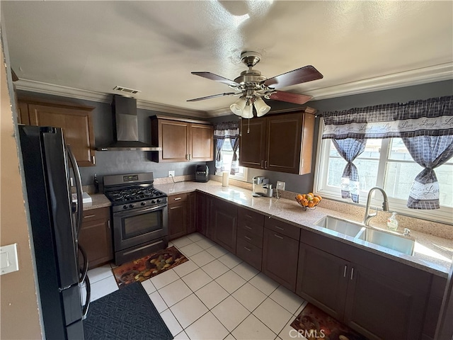 kitchen featuring crown molding, wall chimney exhaust hood, sink, light tile patterned floors, and stainless steel appliances