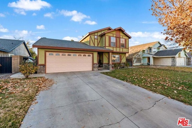 view of front of property featuring a garage and a front lawn