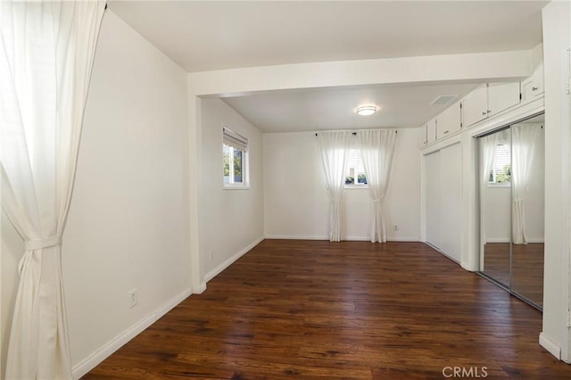 unfurnished room featuring dark hardwood / wood-style flooring