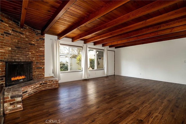 unfurnished living room with wooden ceiling, dark hardwood / wood-style floors, beamed ceiling, and a brick fireplace