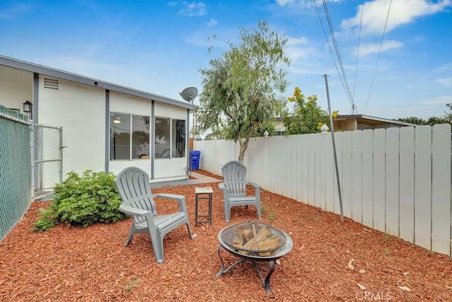 view of patio / terrace featuring an outdoor fire pit