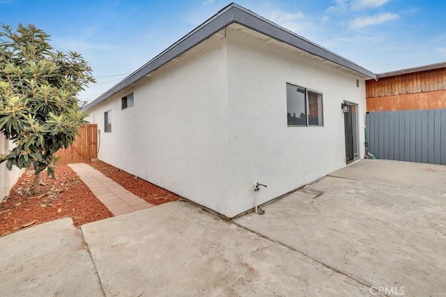 view of side of home with a patio area