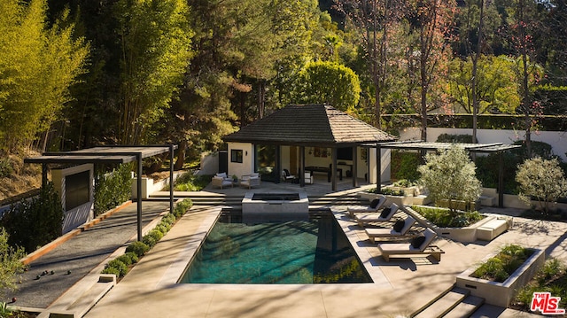 view of pool with an outdoor fire pit, a patio, and an outbuilding