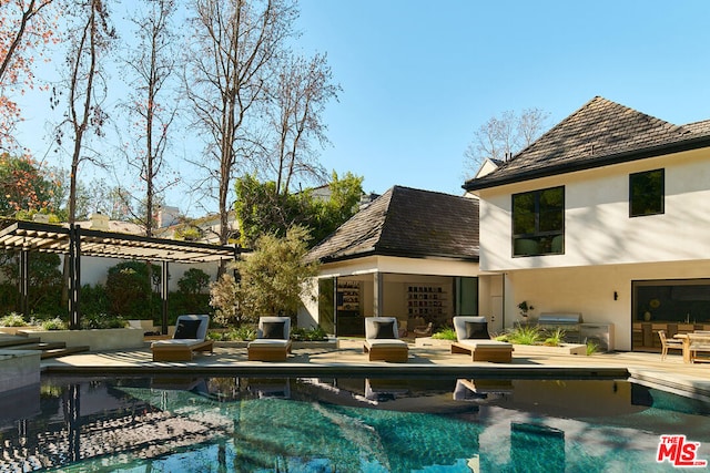 back of property with a patio and a pergola