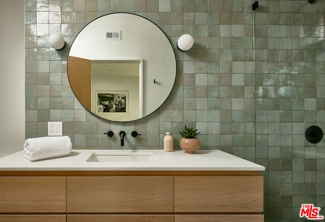 bathroom featuring backsplash, tile walls, and vanity