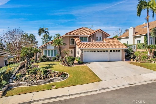 mediterranean / spanish-style home with a garage and a front lawn