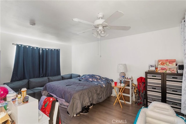 bedroom with hardwood / wood-style floors and ceiling fan