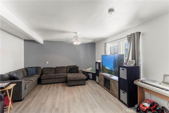 living room with ceiling fan and light hardwood / wood-style floors