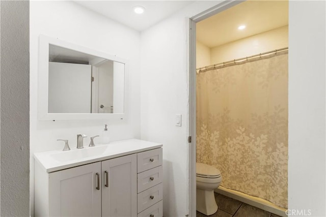 bathroom featuring vanity, toilet, curtained shower, and tile patterned flooring