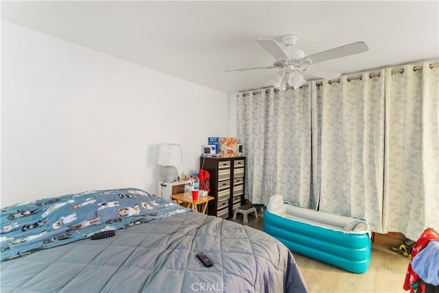 bedroom featuring ceiling fan and wood-type flooring