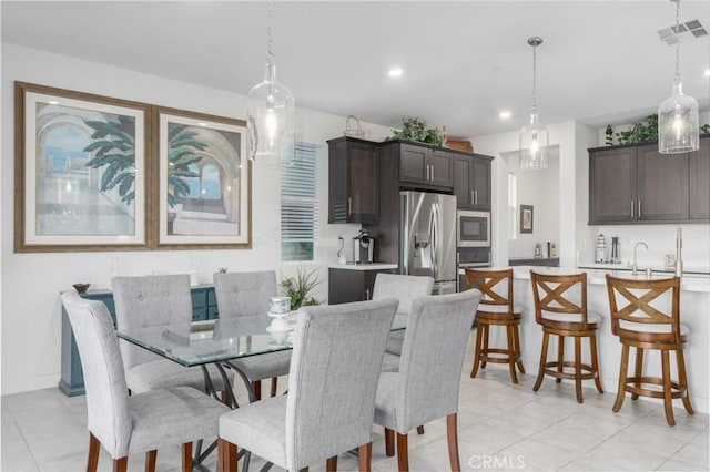 tiled dining room featuring sink