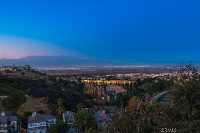 aerial view at dusk featuring a mountain view