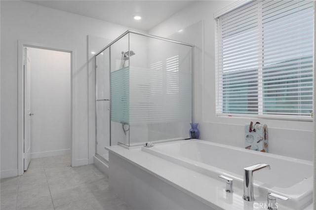 bathroom with separate shower and tub and tile patterned flooring