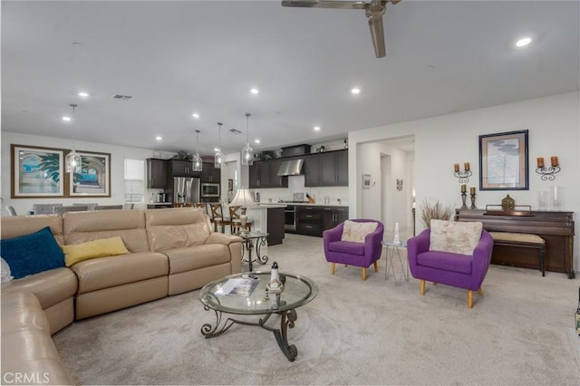 carpeted living room featuring ceiling fan