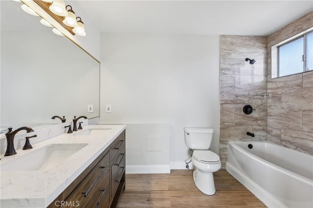 full bathroom with vanity, toilet, and tiled shower / bath