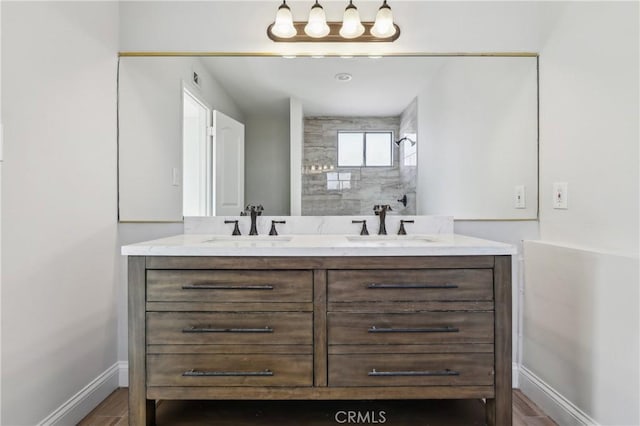 bathroom featuring a tile shower, hardwood / wood-style floors, and vanity