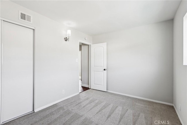 unfurnished bedroom with carpet and a closet