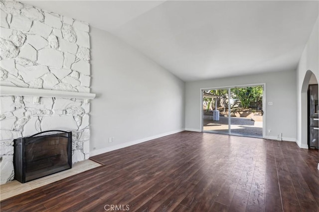 unfurnished living room featuring a fireplace, hardwood / wood-style floors, and lofted ceiling