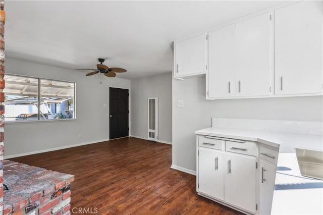 kitchen with ceiling fan, white cabinetry, and dark hardwood / wood-style floors