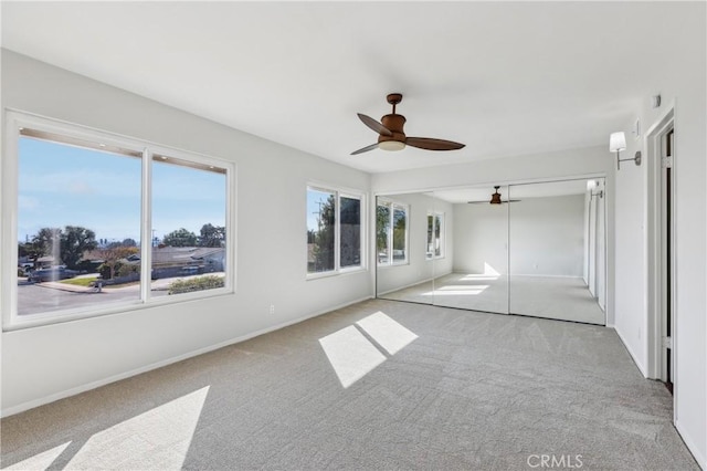 unfurnished bedroom with a closet, ceiling fan, and light colored carpet