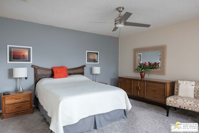 carpeted bedroom with a textured ceiling and ceiling fan