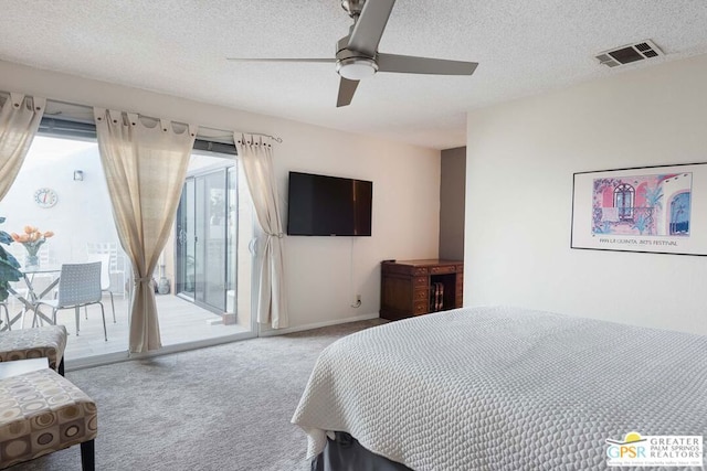 carpeted bedroom featuring a textured ceiling, access to exterior, and ceiling fan