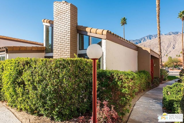 view of side of home featuring a mountain view