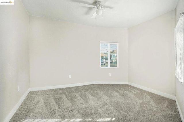 empty room with carpet flooring and ceiling fan