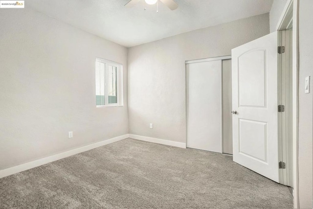 unfurnished bedroom with a closet, ceiling fan, and carpet flooring