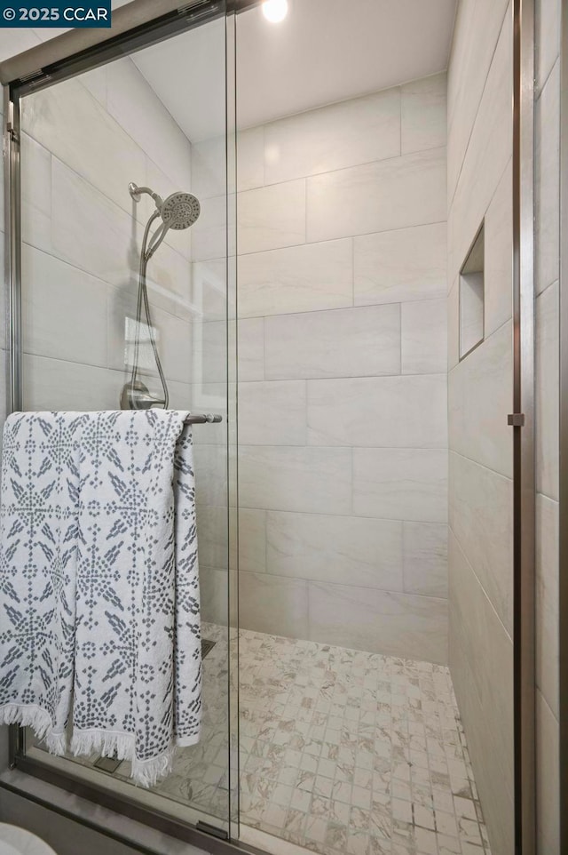 bathroom with a shower with shower door