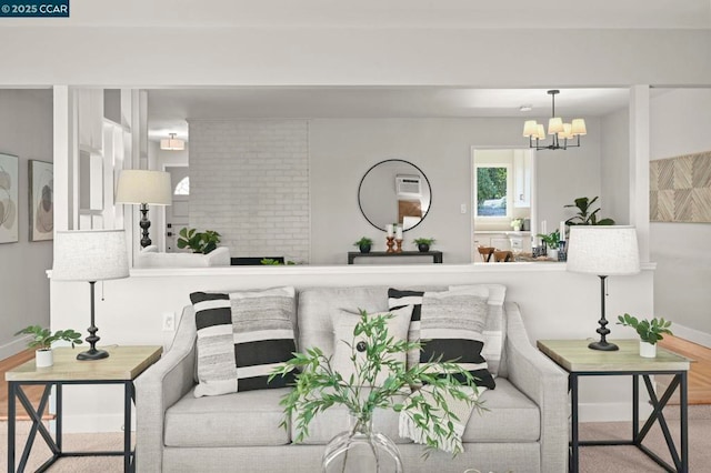 living room featuring an inviting chandelier and light hardwood / wood-style flooring