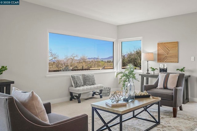 living area featuring light carpet