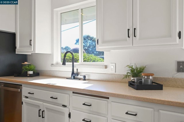 kitchen with white cabinetry, sink, and stainless steel dishwasher