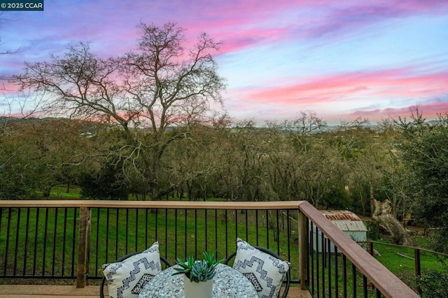 deck at dusk with a lawn