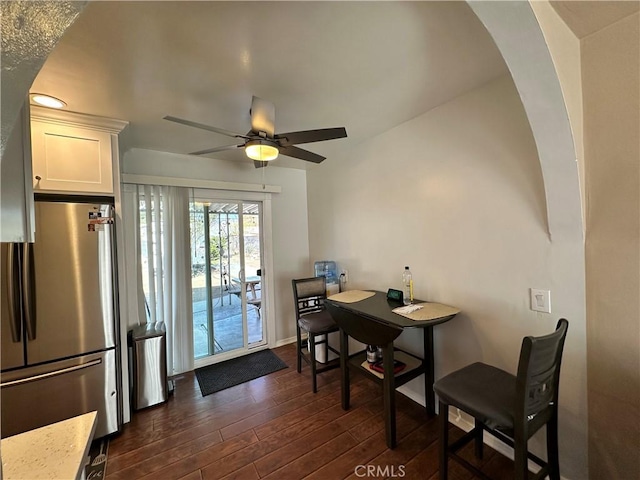 dining area featuring ceiling fan and dark wood-type flooring