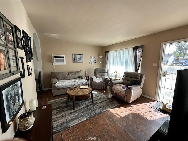 living room featuring a wall mounted AC and wood-type flooring